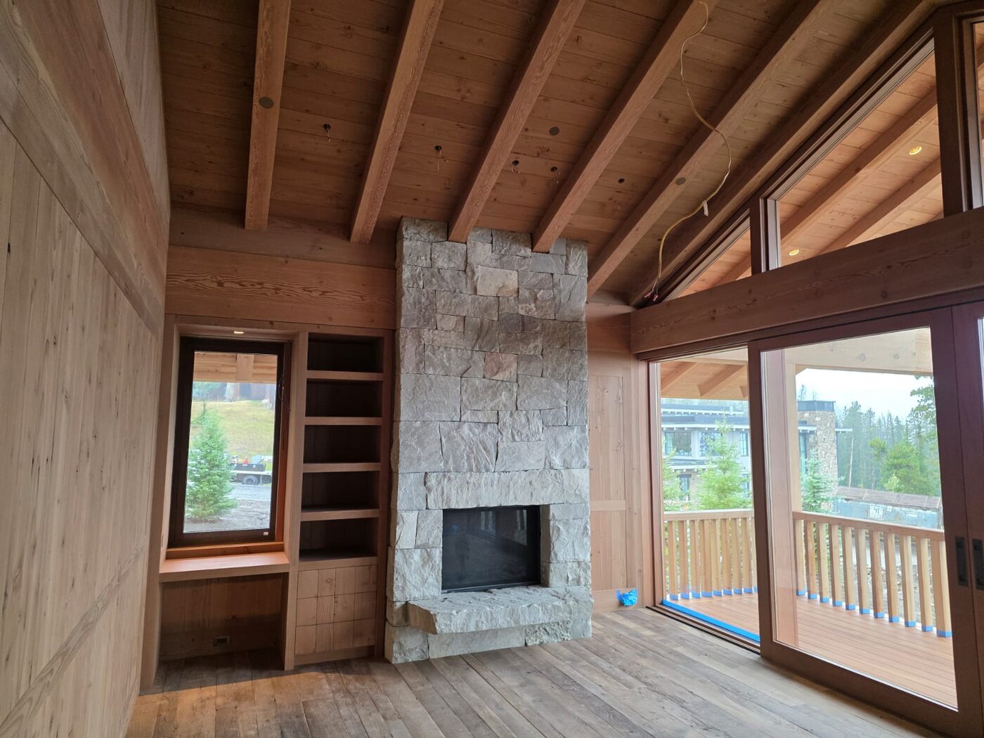 Custom wood ceiling and stone fireplace millwork